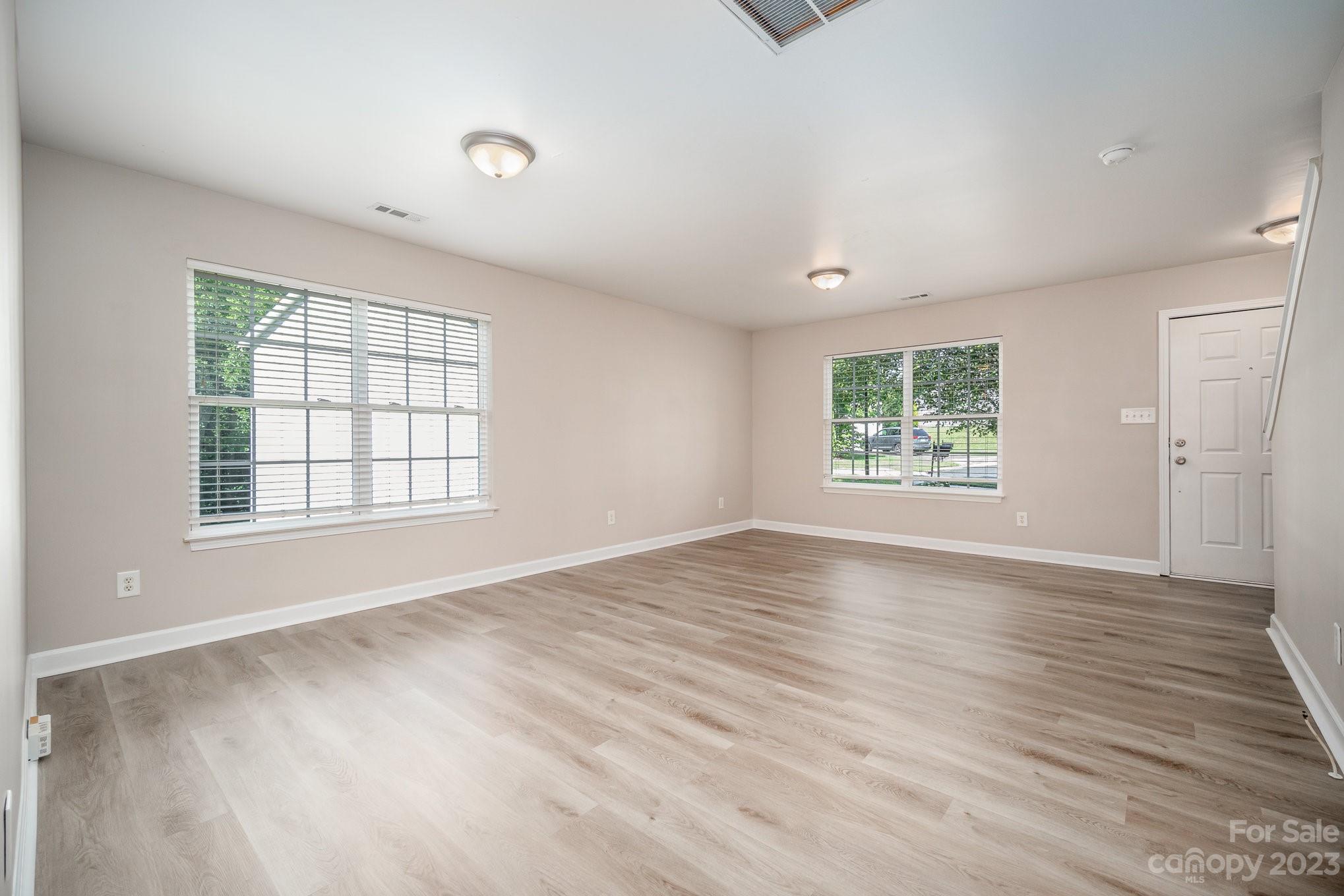 1400 Key Ridge Court Charlotte, NC 28216 - Photo 5 of 27 an empty room with wooden floor and windows