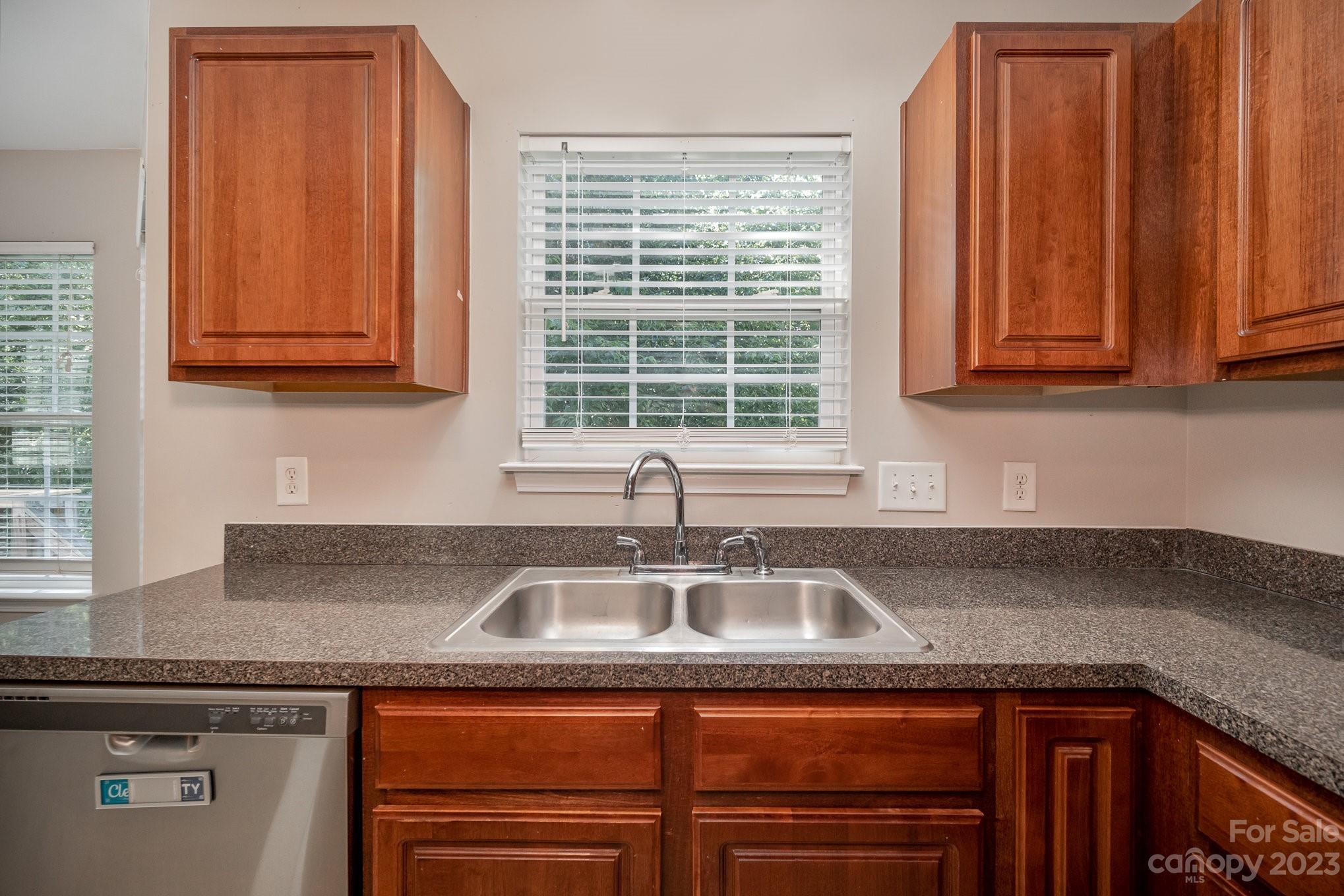 1400 Key Ridge Court Charlotte, NC 28216 - Photo 9 of 27 a kitchen with granite countertop a sink and cabinets