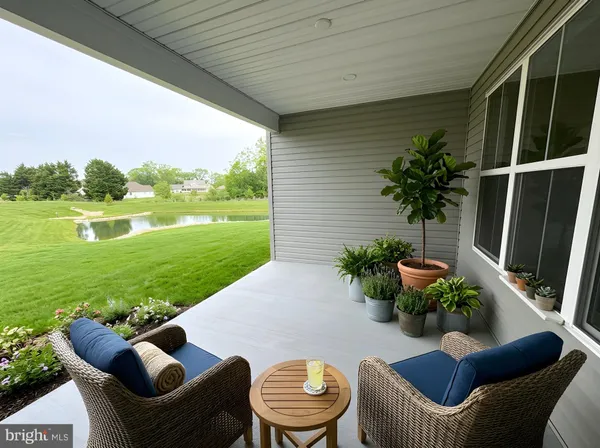 a view of a patio with couches chairs and swimming pool