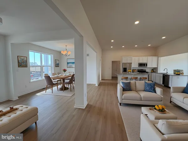 a living room with furniture and kitchen view