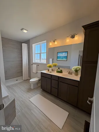 a spacious bathroom with a bathtub sink and toilet