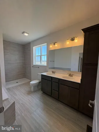 a bathroom with a sink a toilet and bathtub