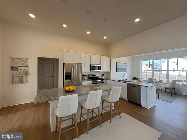 a kitchen with a sink and chairs