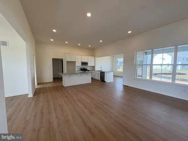a view of kitchen with furniture and wooden floor