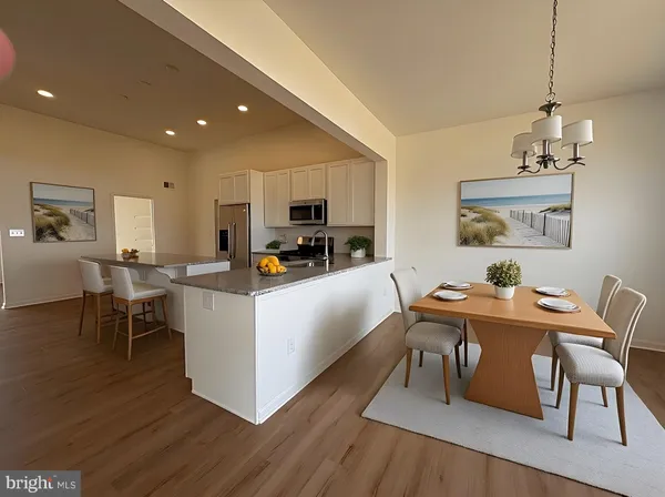a living room with furniture a dining table and chairs with wooden floor