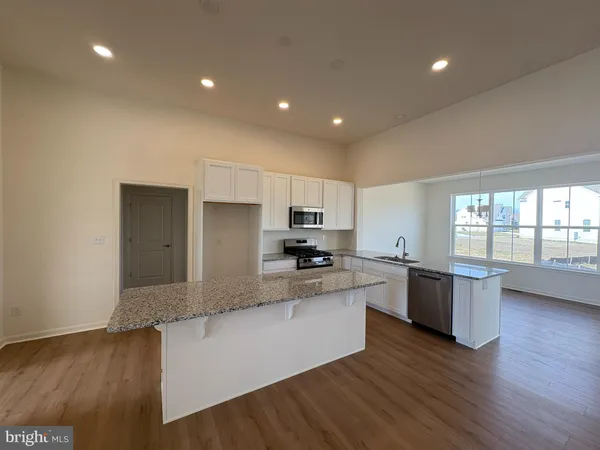 a large kitchen with a large counter top appliances and cabinets