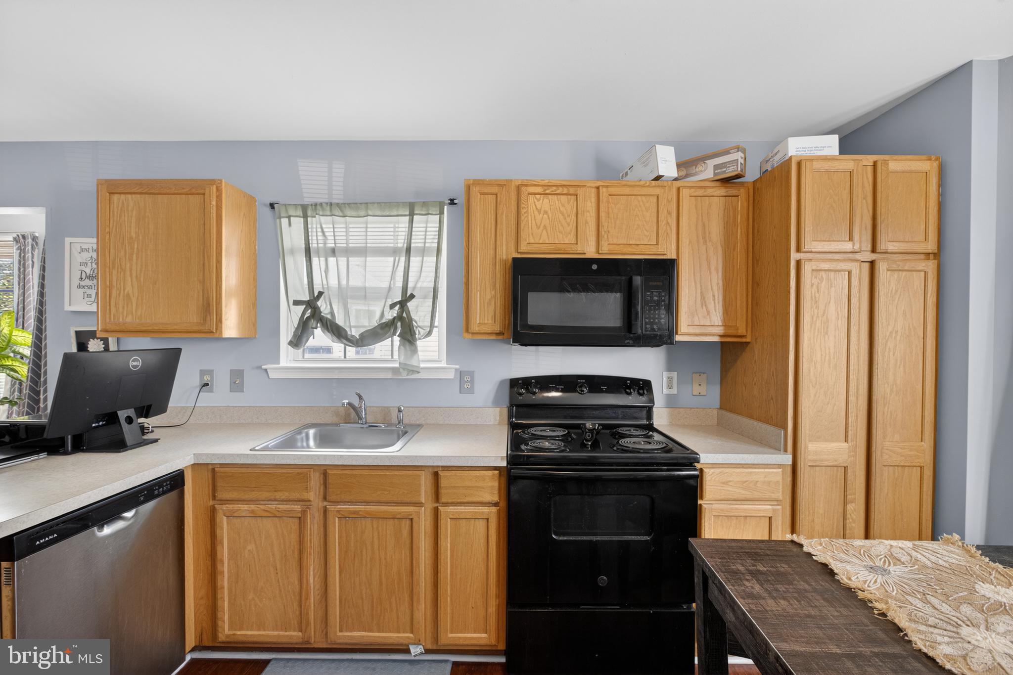 115 Bonnybrook Road Middletown, DE 19709 - Photo 13 of 31 a kitchen with stainless steel appliances a stove sink and microwave