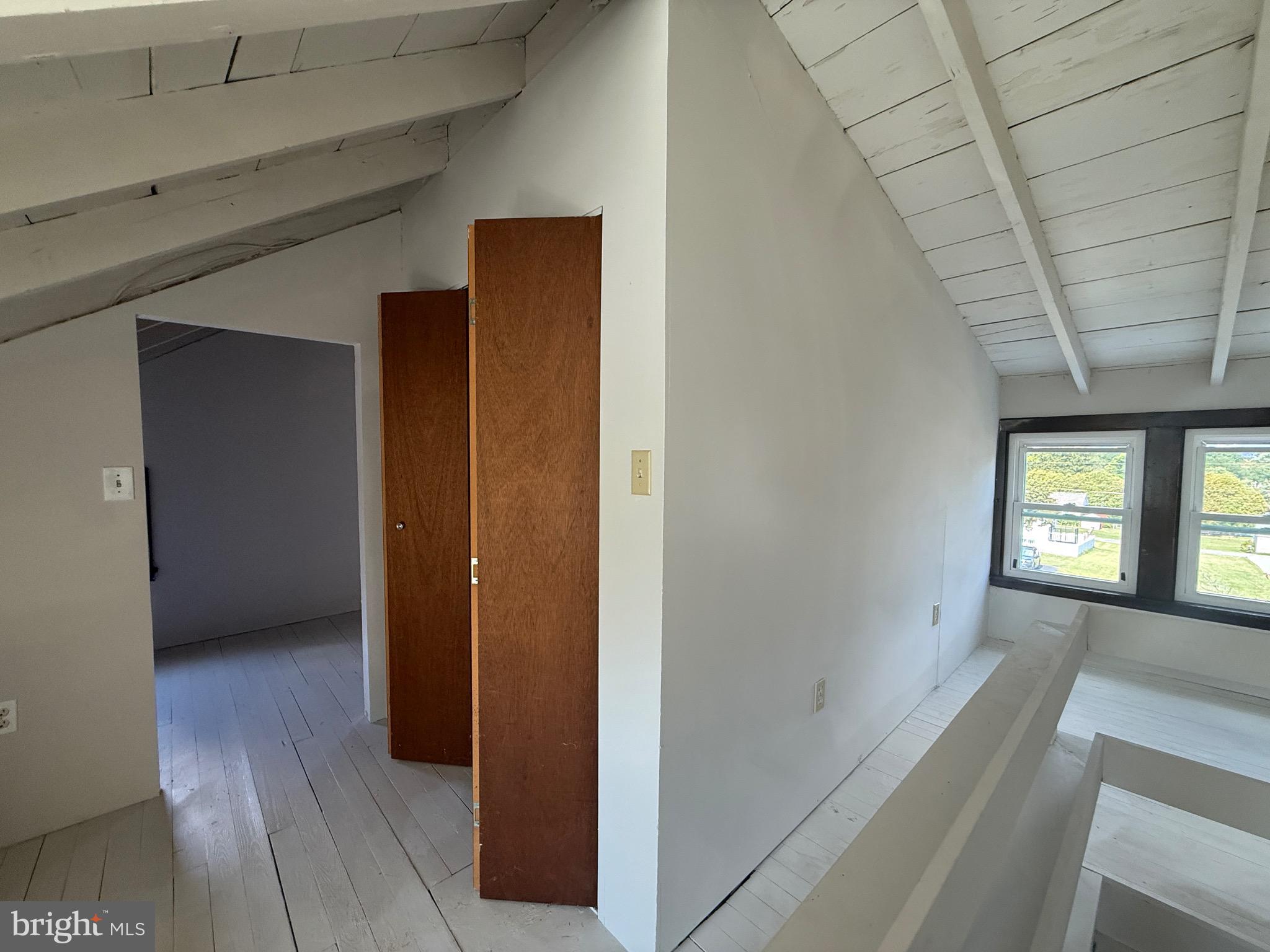 224 Pershing Boulevard Reading, PA 19607 - Photo 15 of 24 a view of a hallway with wooden floor and windows