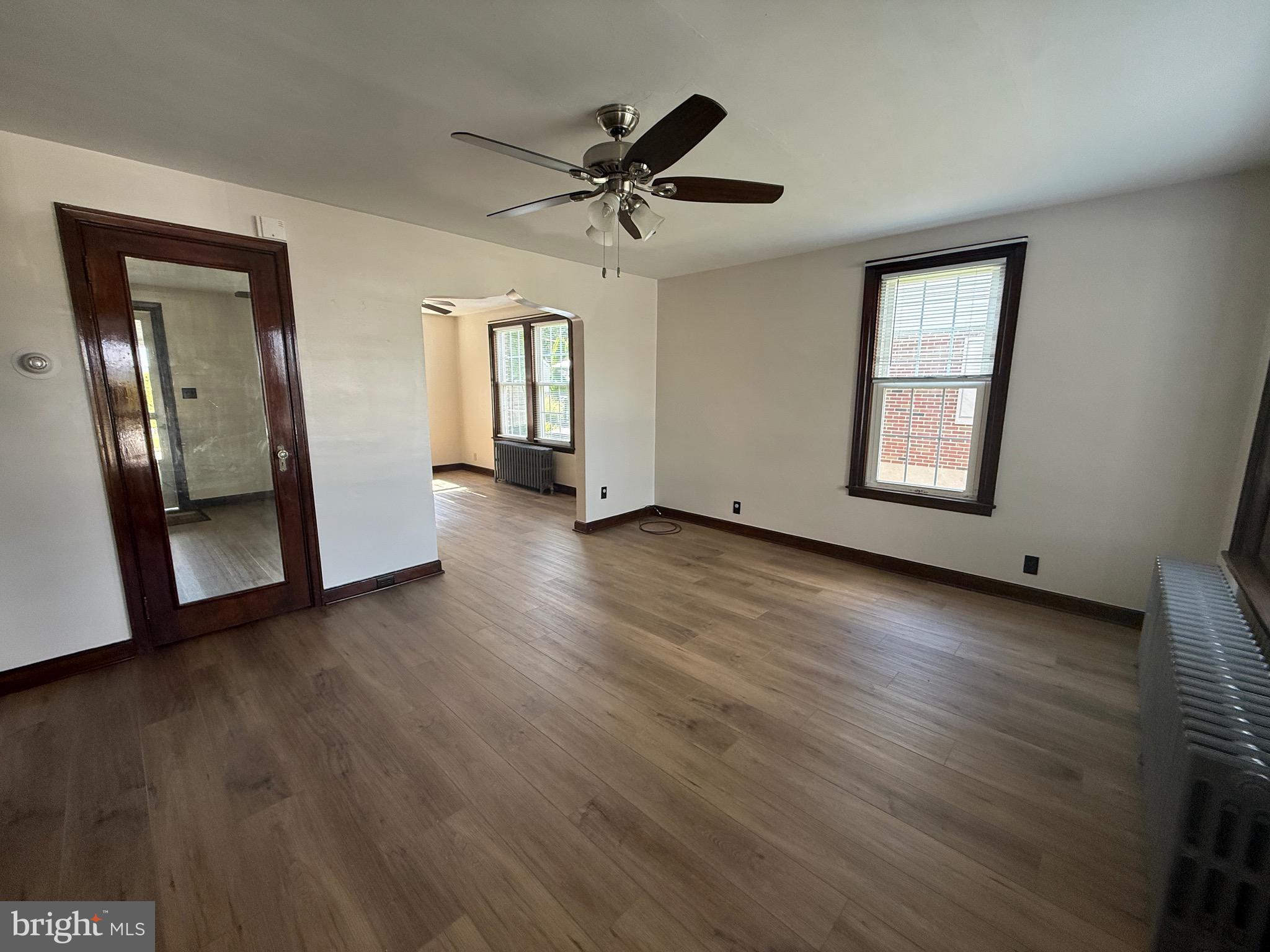 224 Pershing Boulevard Reading, PA 19607 - Photo 3 of 24 a view of a livingroom with wooden floor and a ceiling fan