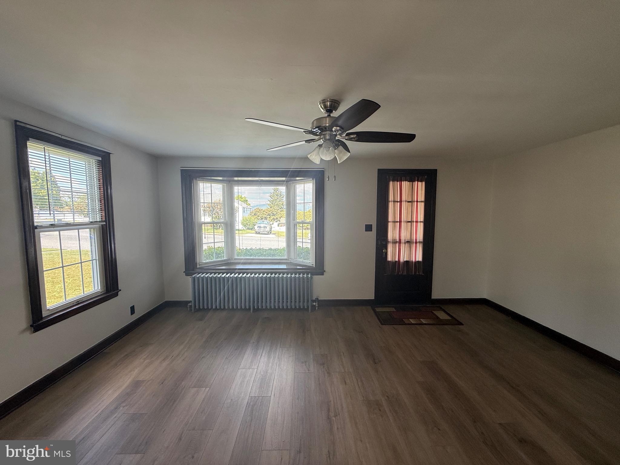 224 Pershing Boulevard Reading, PA 19607 - Photo 4 of 24 a view of an empty room with a window and wooden floor