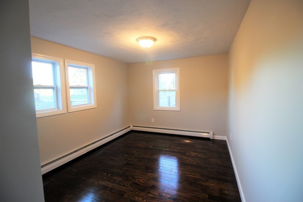 61 Chipaway Road Freetown, MA 02717 - Photo 11 of 27 a view of an empty room with wooden floor and a window