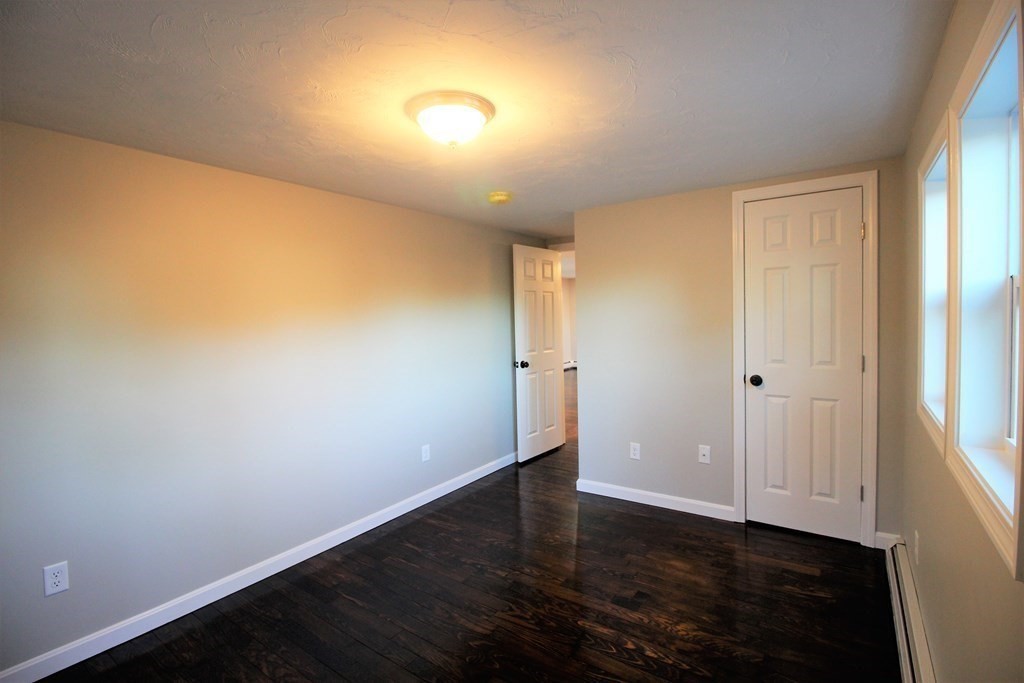61 Chipaway Road Freetown, MA 02717 - Photo 12 of 27 an empty room with wooden floor and windows