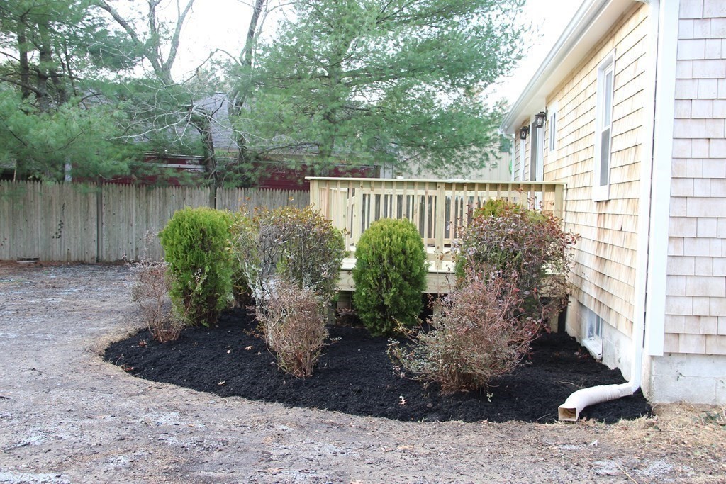 61 Chipaway Road Freetown, MA 02717 - Photo 20 of 27 a view of a backyard with plants and a tree