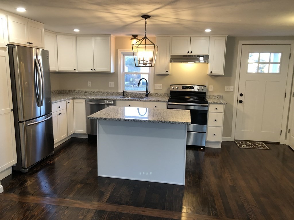61 Chipaway Road Freetown, MA 02717 - Photo 5 of 27 a kitchen with granite countertop a stove and a refrigerator