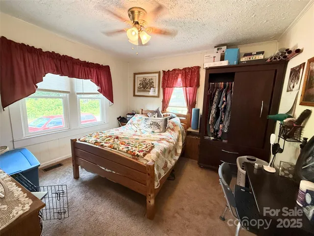 a bedroom with bed and a window