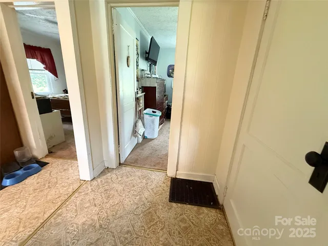 a view of a hallway view with wooden floor and living room