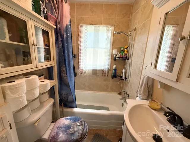 a bathroom with a sink a toilet and a bathtub