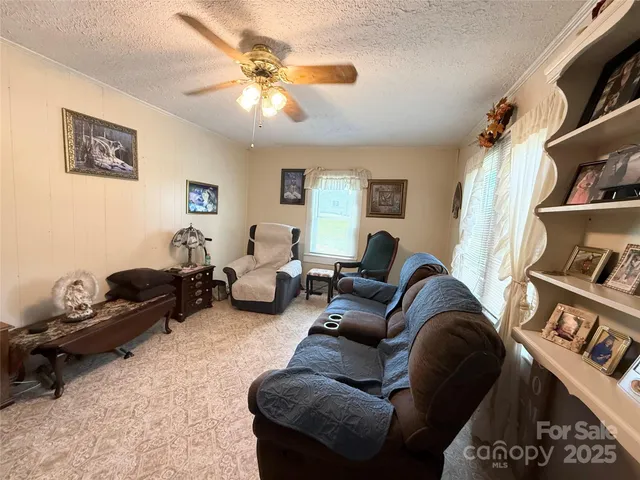 a living room with furniture a rug and a window