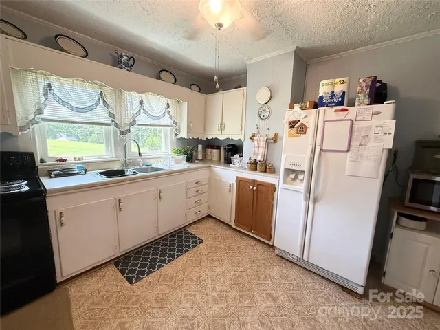 a kitchen with sink cabinets and window