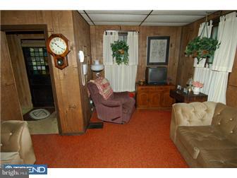 810 Angora Road Reading, PA 19606 - Photo 3 of 11 a living room with furniture a window and a clock
