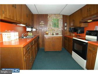 810 Angora Road Reading, PA 19606 - Photo 5 of 11 a kitchen with stainless steel appliances granite countertop a stove a sink a refrigerator and wooden cabinets