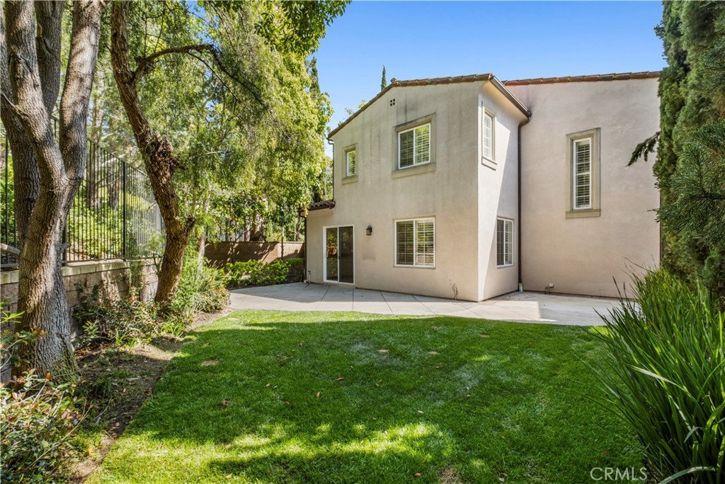 61 Bellwind Irvine, CA 92603 - Photo 17 of 23 a front view of a house with a yard and trees