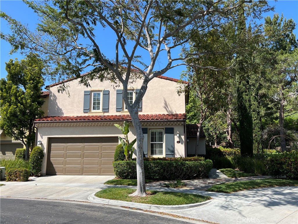 61 Bellwind Irvine, CA 92603 - Photo 2 of 23 a front view of a house with a yard and garage