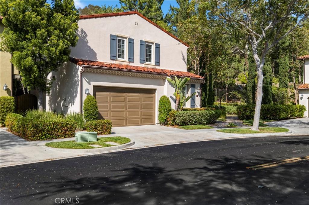61 Bellwind Irvine, CA 92603 - Photo 23 of 23 a front view of a house with a yard and garage