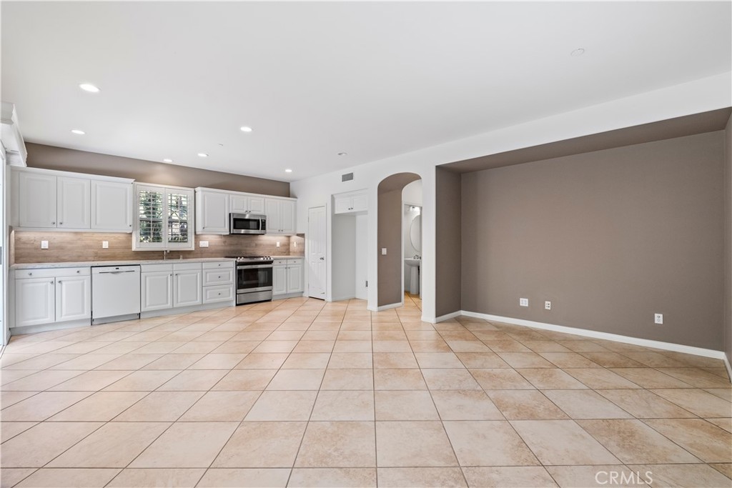 61 Bellwind Irvine, CA 92603 - Photo 5 of 23 a large white kitchen with a cabinetry and a sink
