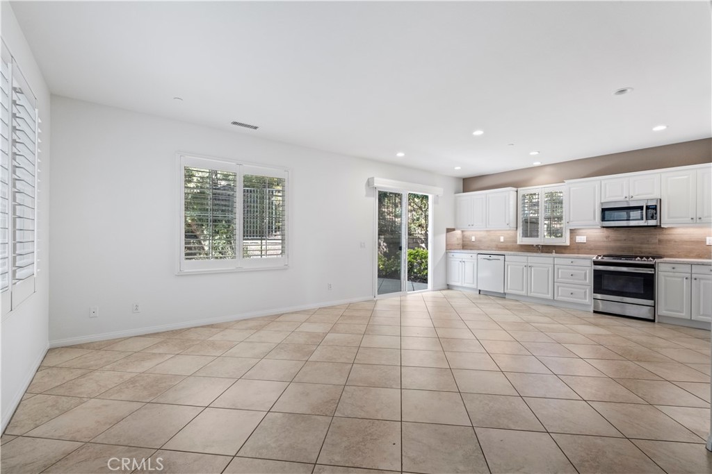 61 Bellwind Irvine, CA 92603 - Photo 6 of 23 a view of a kitchen with microwave and windows