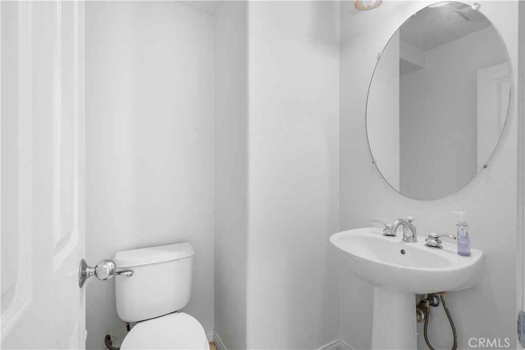 61 Bellwind Irvine, CA 92603 - Photo 9 of 23 a bathroom with a toilet sink and mirror