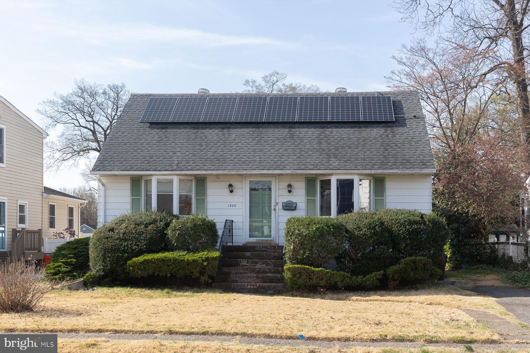 a view of a house with a yard and plants