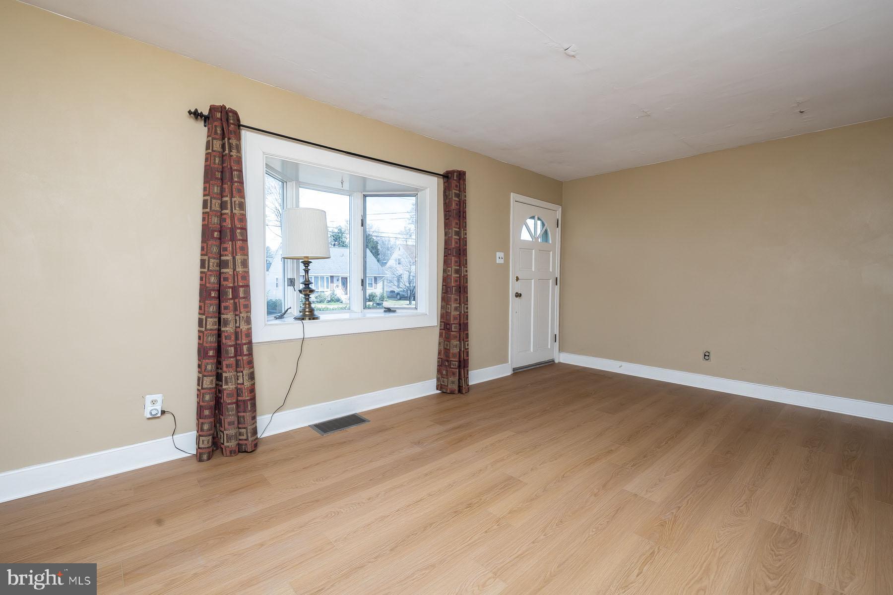 1520 Chestnut Avenue Haddon Heights, NJ 08035 - Photo 5 of 33 an empty room with wooden floor and windows