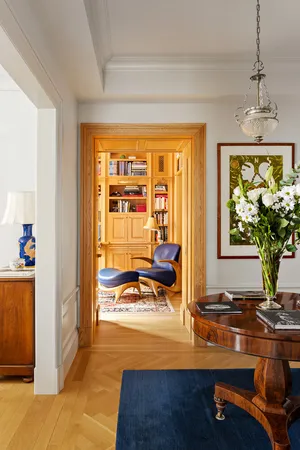 a view of a livingroom with wooden floor and a potted plant