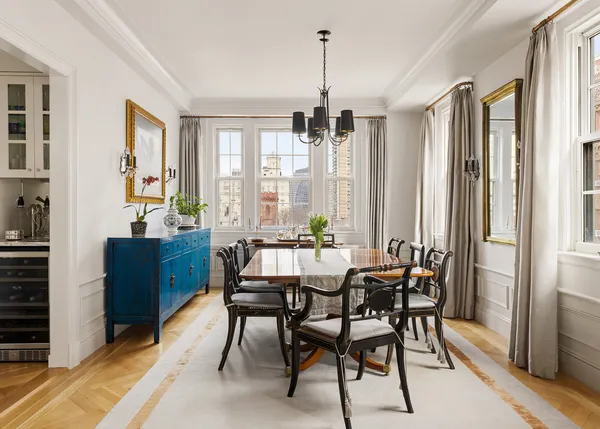 a living room with furniture a flat screen tv and a window