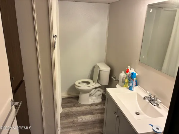 a bathroom with a sink vanity mirror and toilet