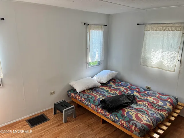 a bed sitting in a bedroom next to a window