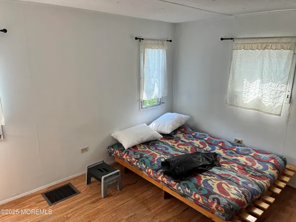 a bed sitting in a bedroom next to a window
