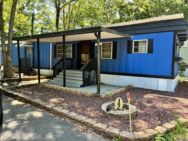 a backyard of a house with barbeque oven
