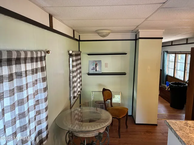 a dining room with furniture and wooden floor