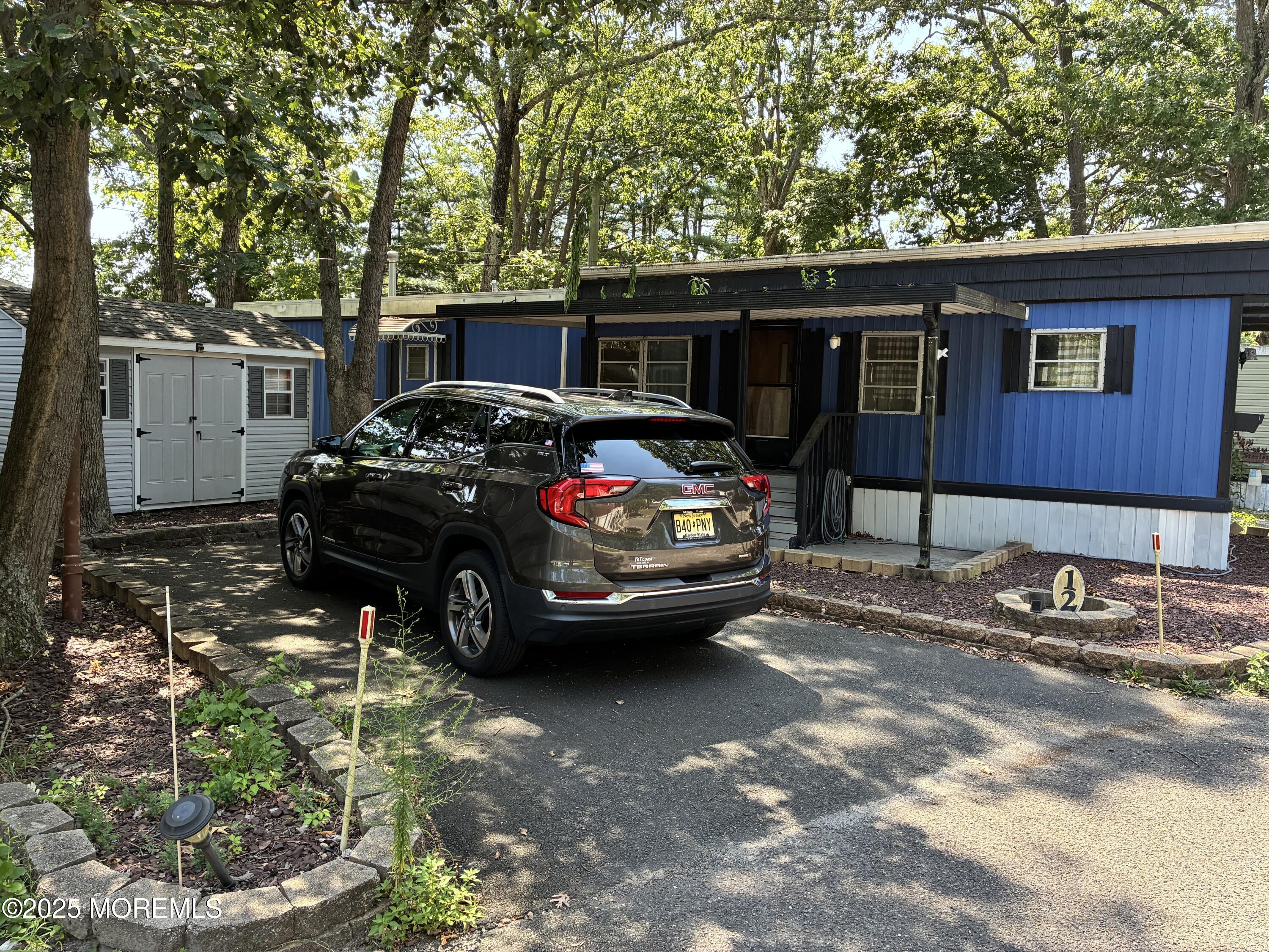 12 D Trail Brick, NJ 08724 - Photo 8 of 17 a car parked in front of a house