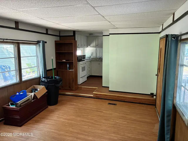 a living room with furniture gym equipment and a large window