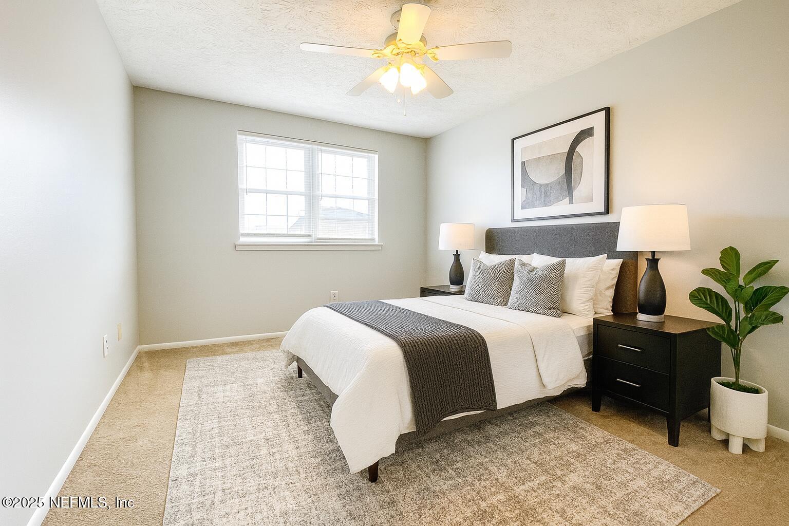 4915 Baymeadows Road, Unit 13D Jacksonville, FL 32217 - Photo 13 of 23 a bed room with a bed and a chandelier
