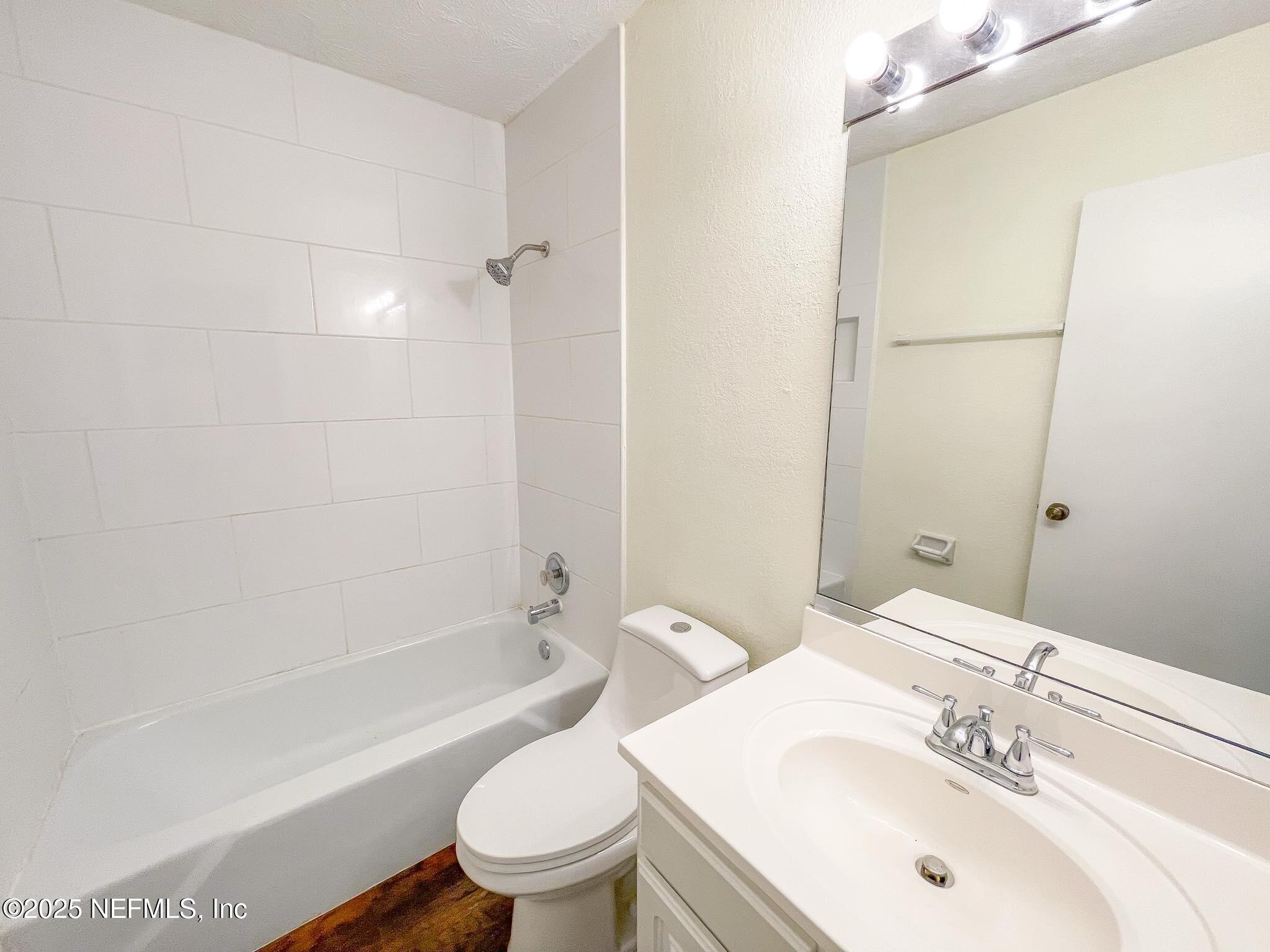 4915 Baymeadows Road, Unit 13D Jacksonville, FL 32217 - Photo 14 of 23 a bathroom with a sink toilet and shower