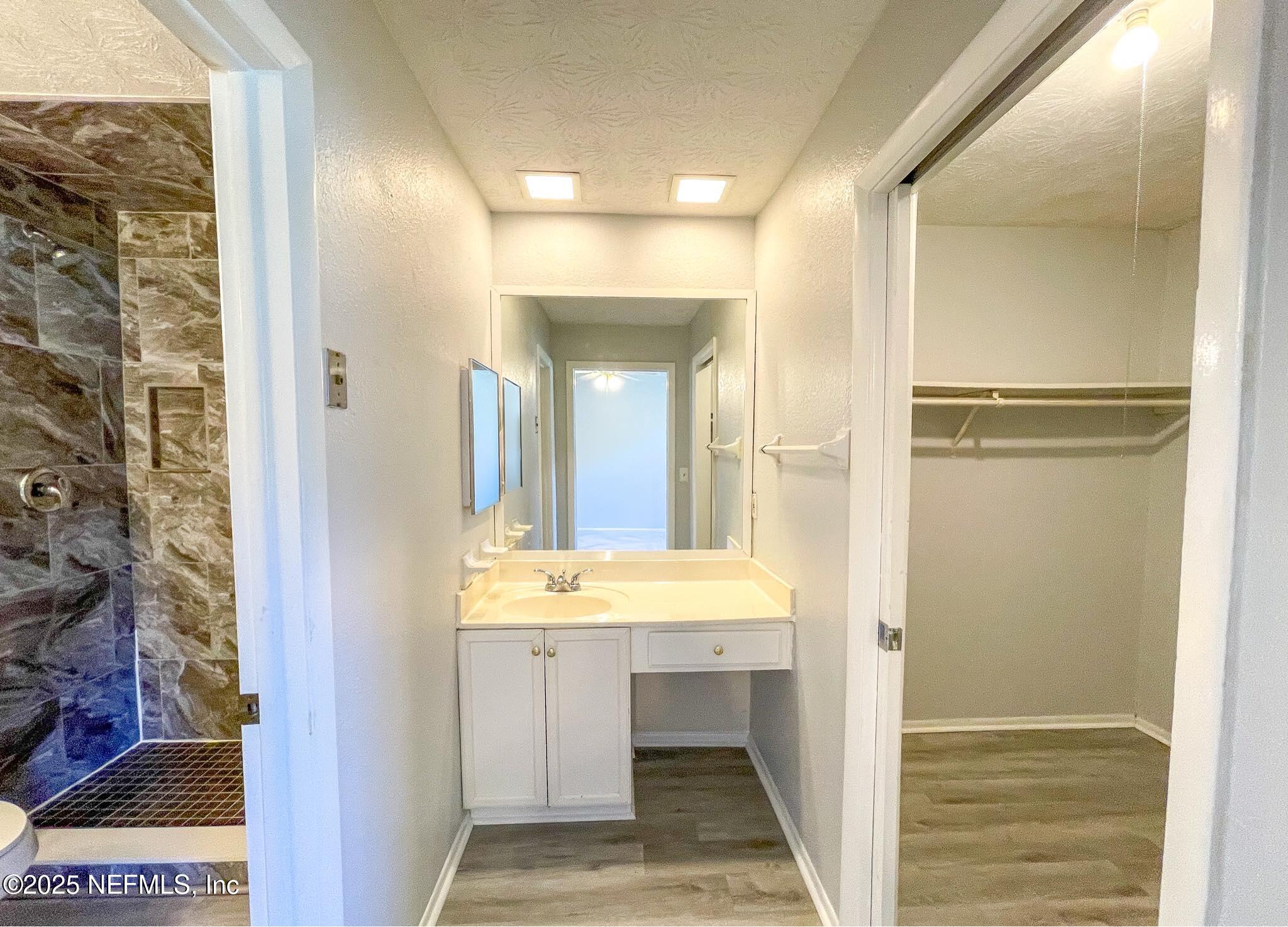 4915 Baymeadows Road, Unit 13D Jacksonville, FL 32217 - Photo 18 of 23 a bathroom with a sink and a mirror