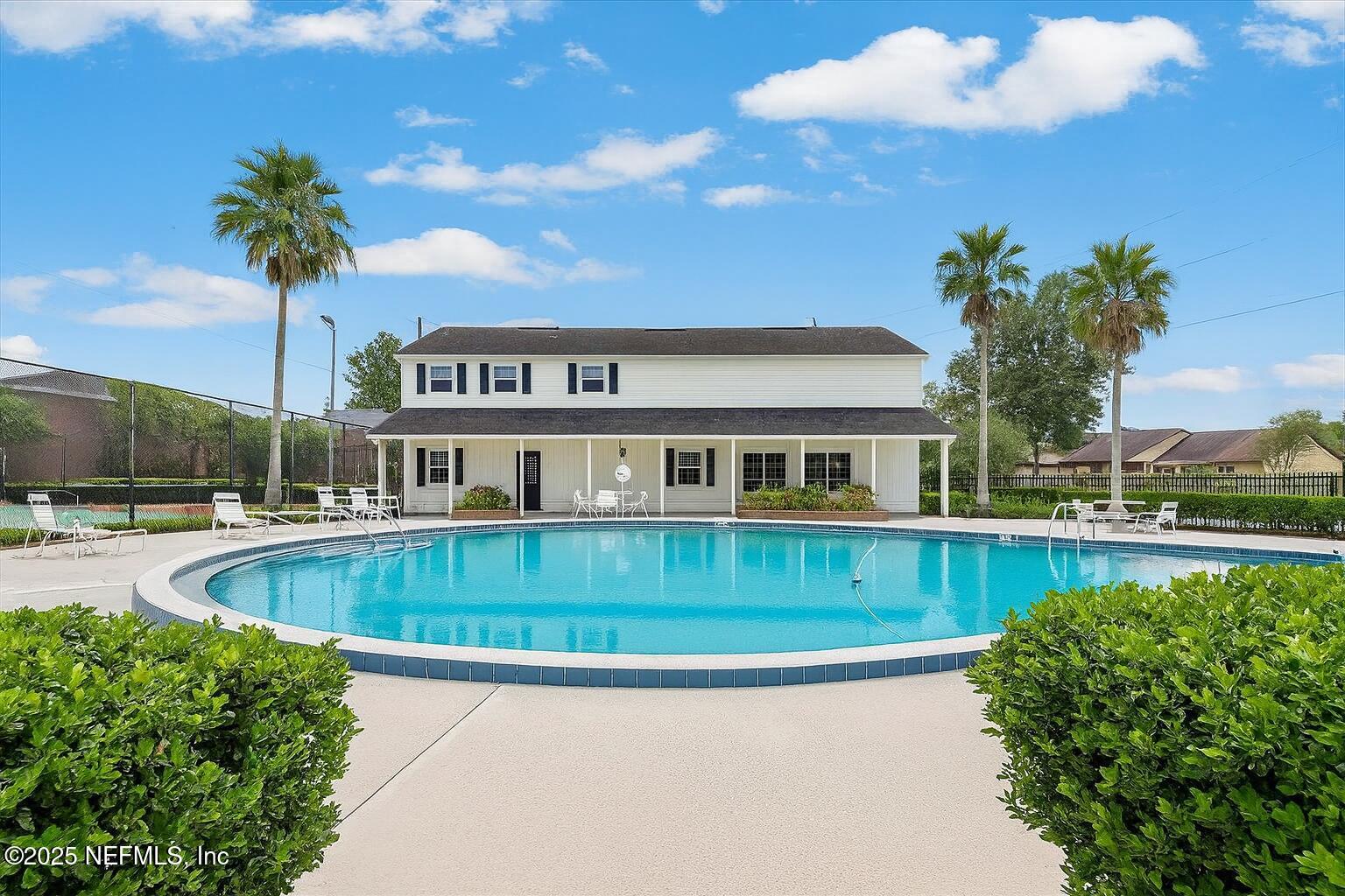 4915 Baymeadows Road, Unit 13D Jacksonville, FL 32217 - Photo 22 of 23 a front view of a house with swimming pool having outdoor seating