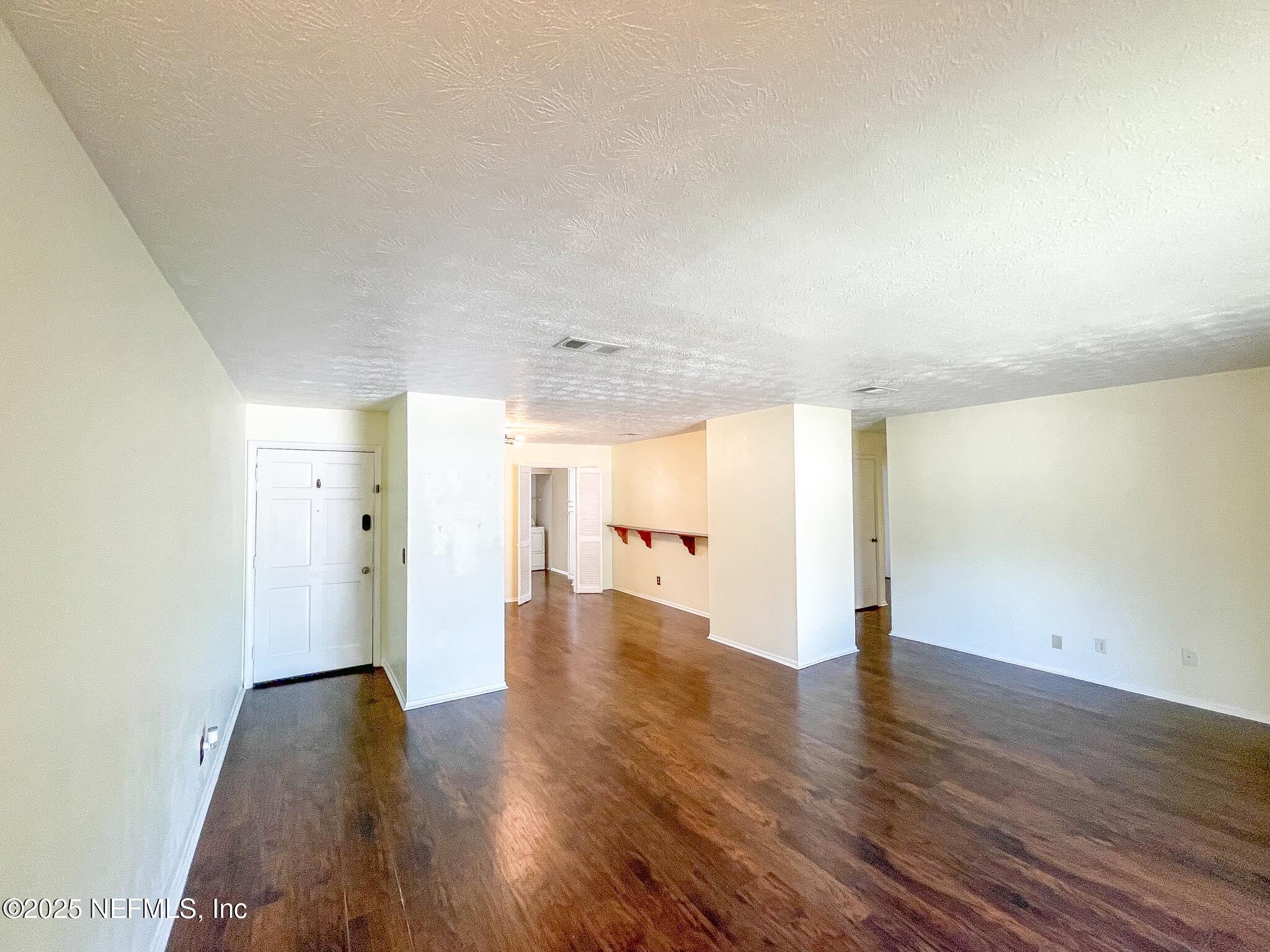 4915 Baymeadows Road, Unit 13D Jacksonville, FL 32217 - Photo 4 of 23 a view of empty room with wooden floor