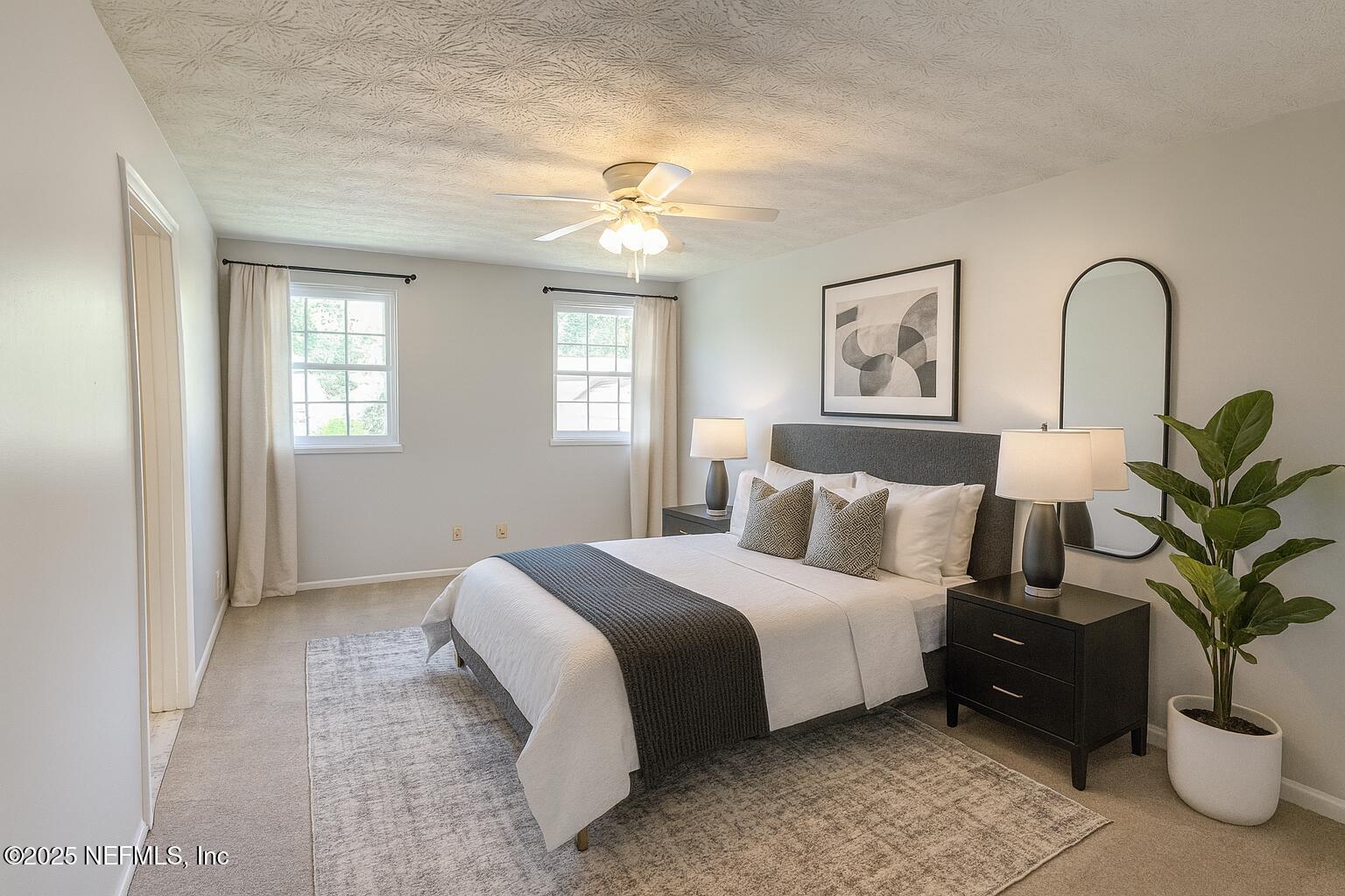 4915 Baymeadows Road, Unit 13D Jacksonville, FL 32217 - Photo 9 of 23 a bedroom with bed and a potted plant