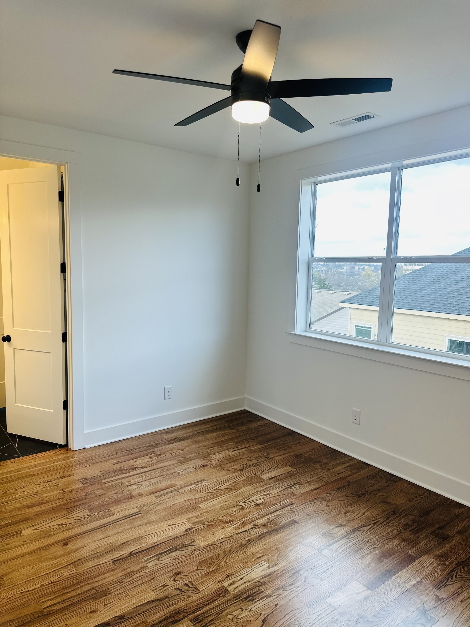 4334 Old Goins Road Nashville, TN 37211 - Photo 51 of 74 a view of an empty room with wooden floor and a window