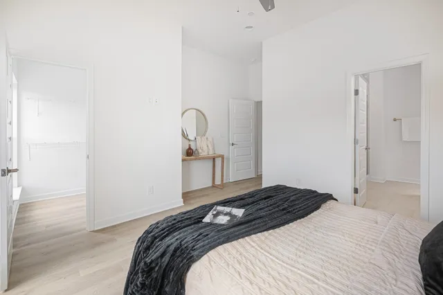 a bedroom with a bed and wooden floor